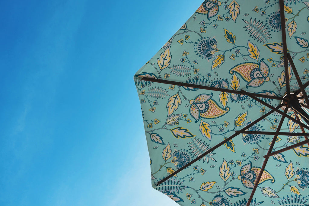 Parasol with ethnic print fabric, adding style and colour to garden furniture.